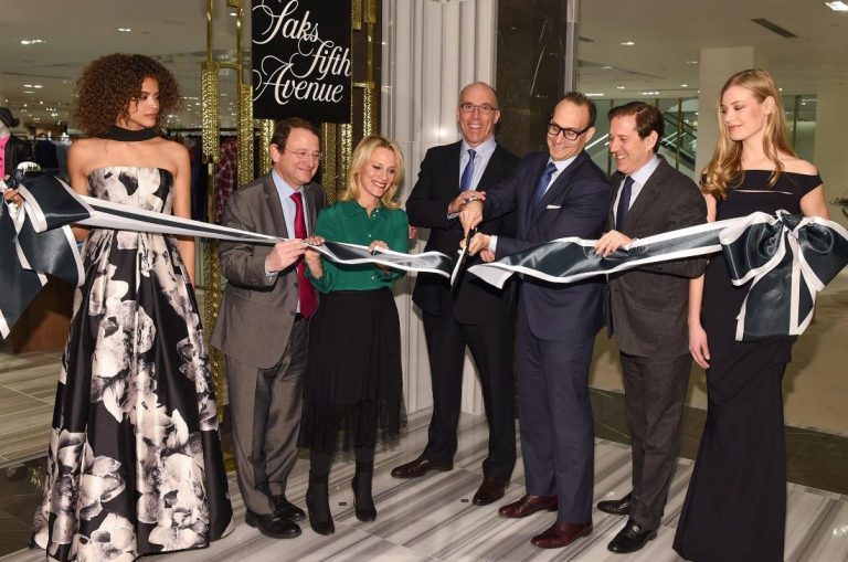 Saks Fifth Avenue CEO in a ribbon cutting ceremony