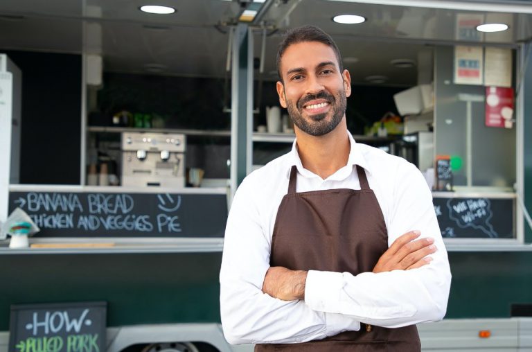 small business owner in front of a food truck