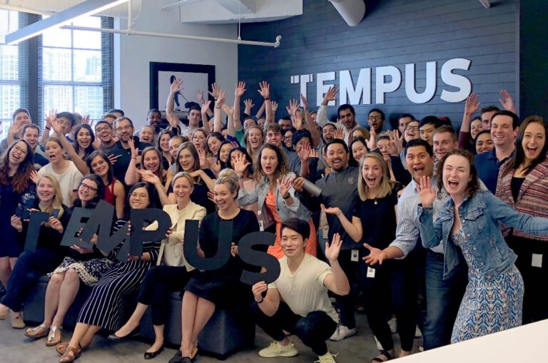 Tempus staff celebrate in their head office