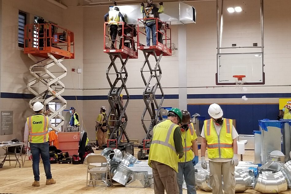 The Conti Group staff assemble HVAC system in basketball court