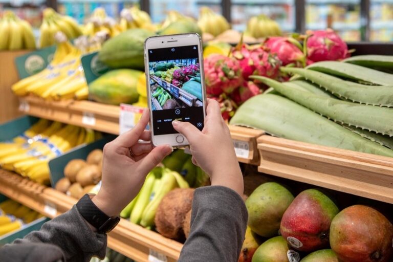 Customer takes picture of fresh fruit at grocery store