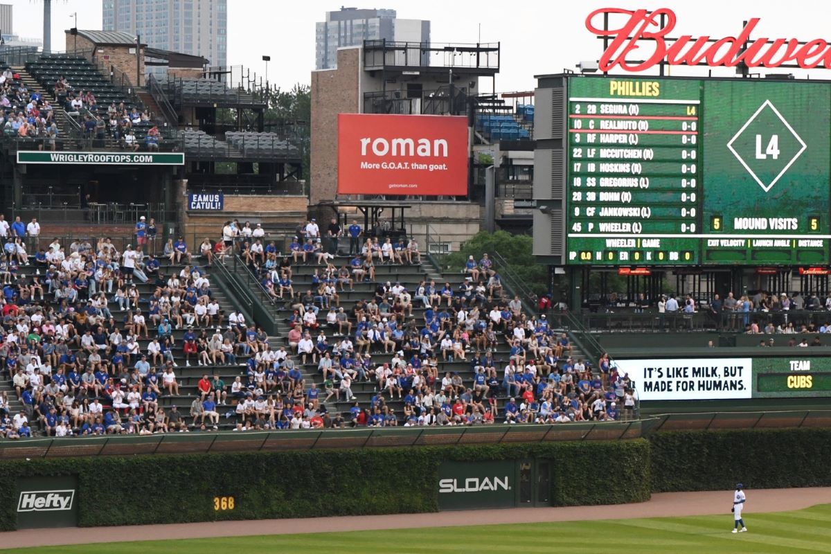 Ro sub-brand Roman ads board at a baseball field