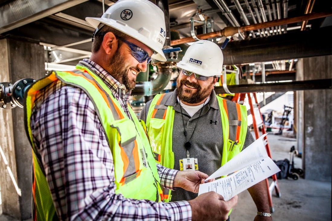 Polk Mechanical engineers and project manager collaborate at the job site