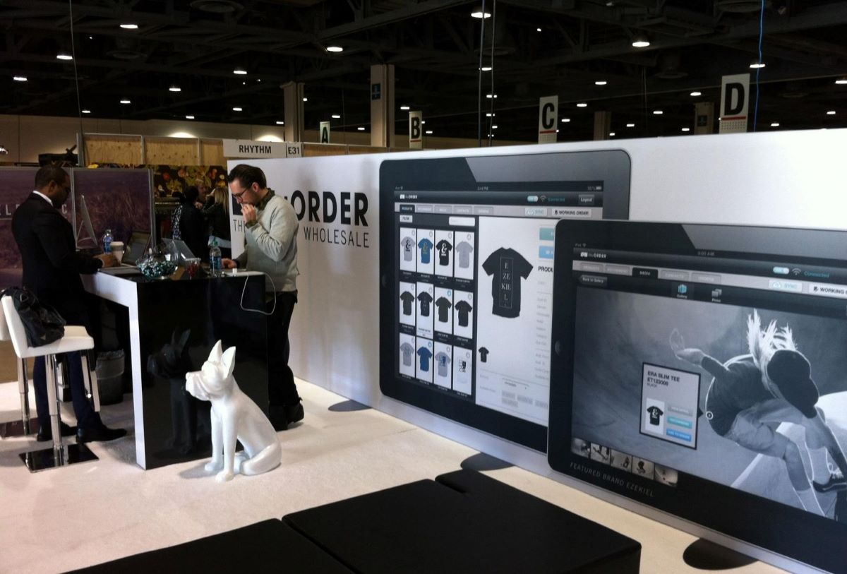 NuORDER staff collaborate with attendees at a trade show