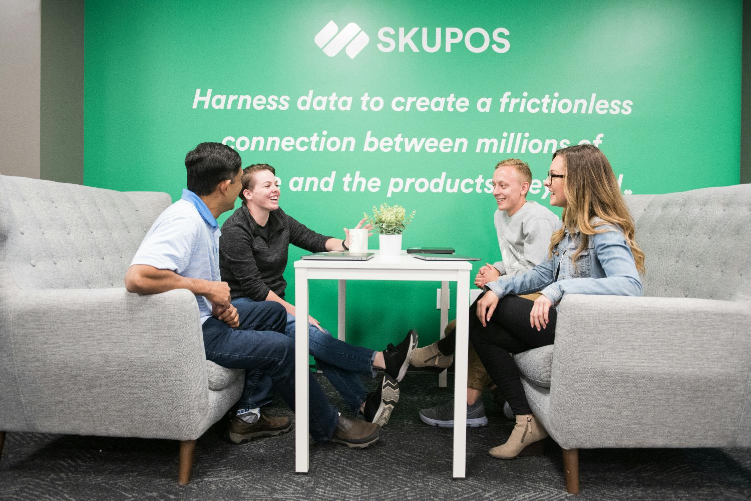 Skupos staff collaborate on project at the office