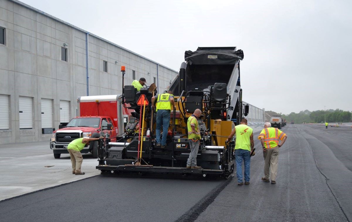 Schlouch staff work on heavy-duty machine to pave