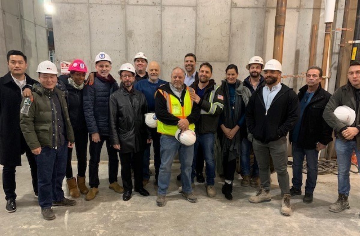 Omnibuild team and the project owner at the job site