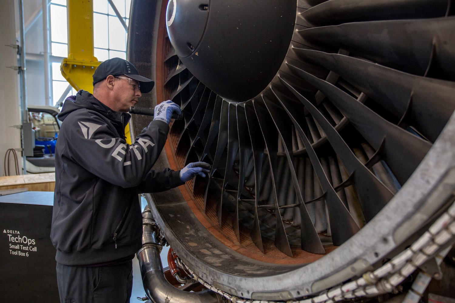 Delta airlines technician inspect jet engine
