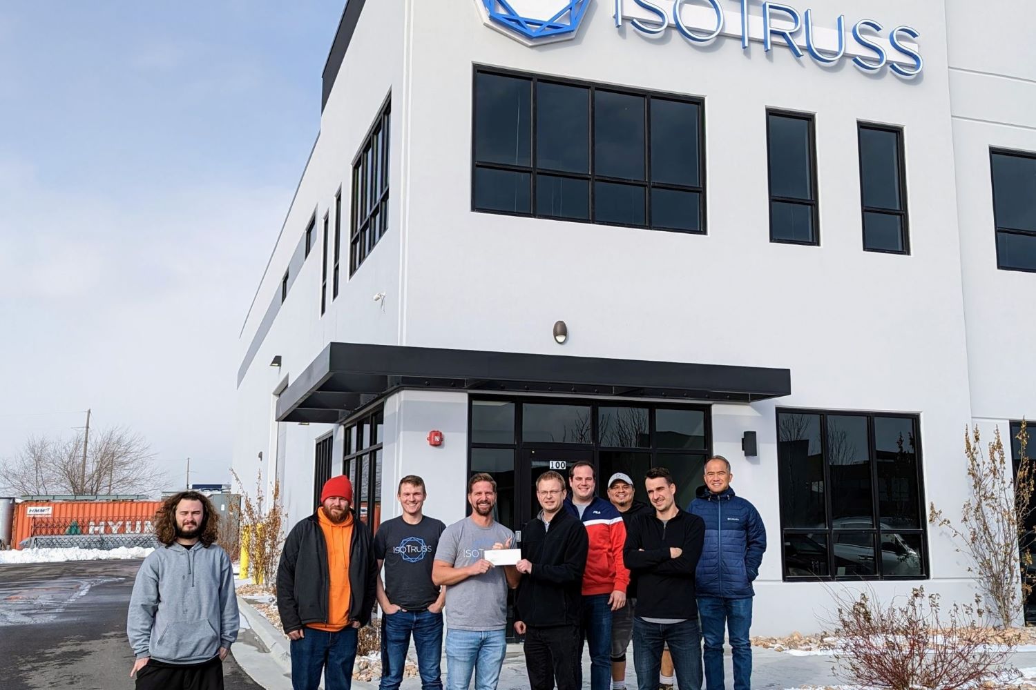 IsoTruss team is in front of its factory