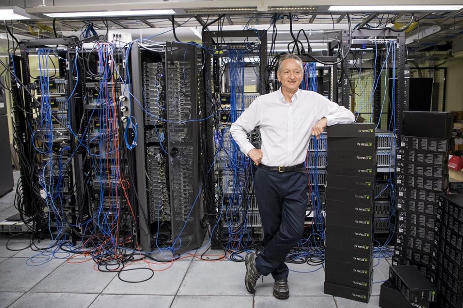 Geoffrey Hinton strikes a relaxed pose in the server room of the machine learning group
