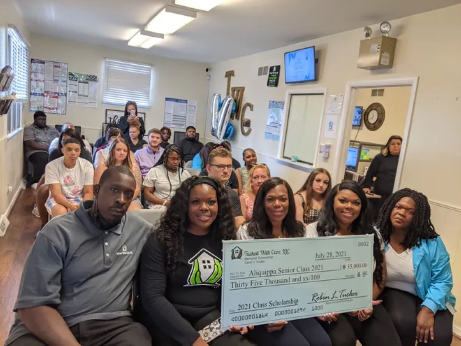 Robin Tucker is awarding a scholarship