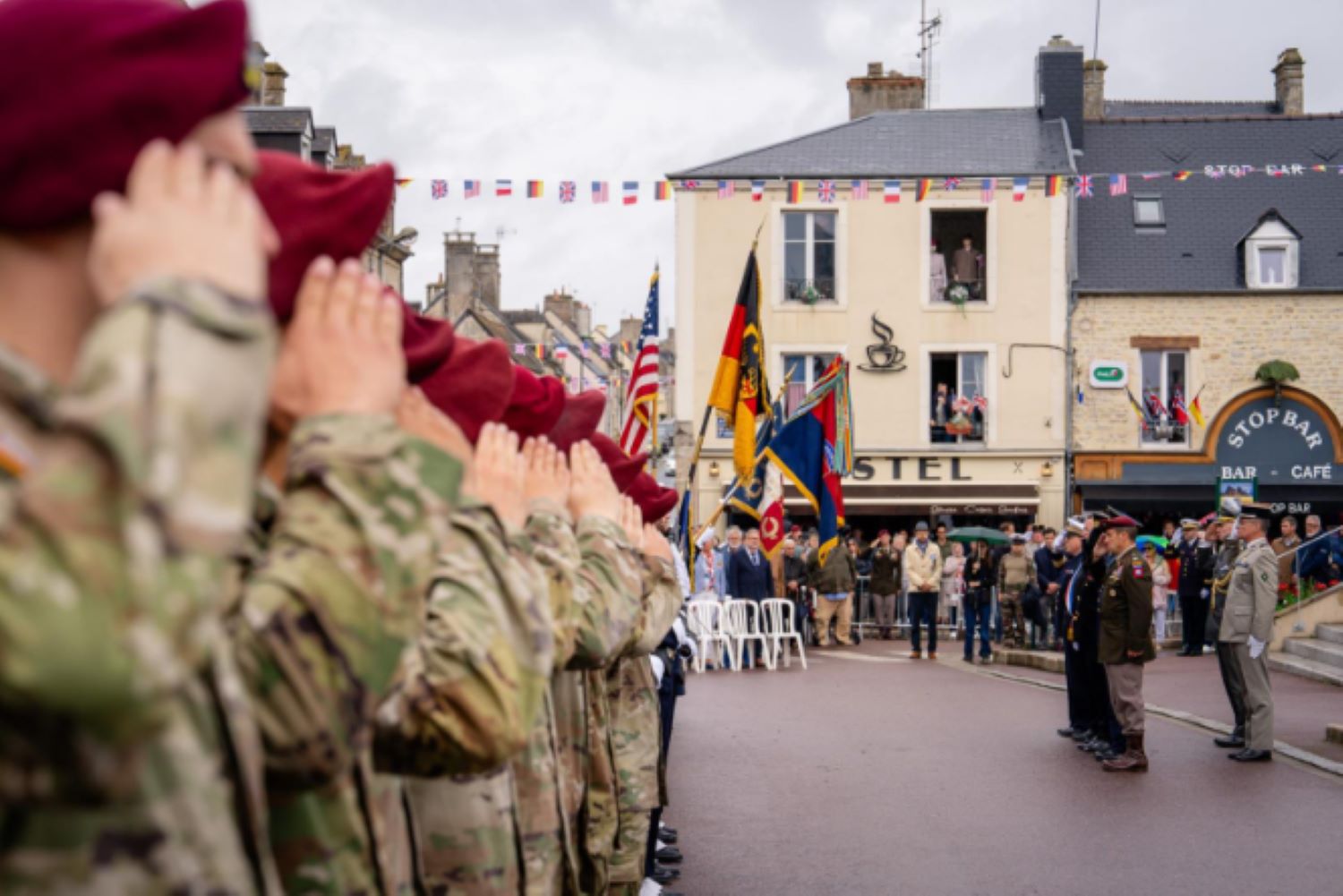 U.S. Army paratroopers from the 173rd Airborne Brigade lift their hands in salute