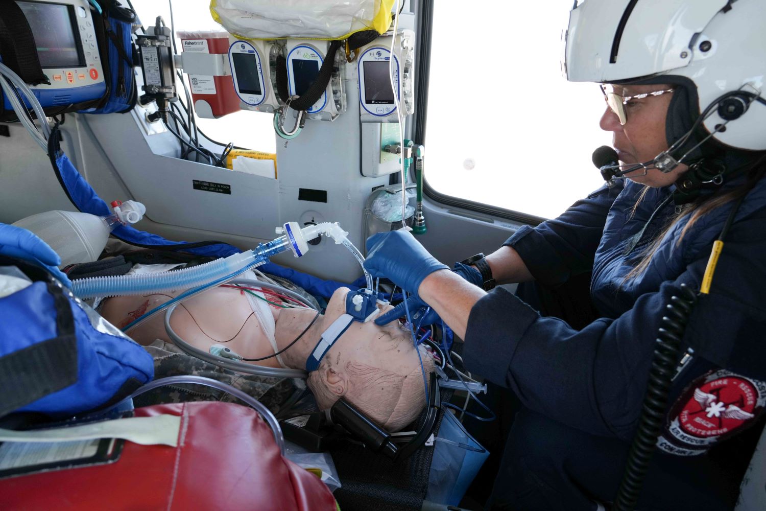 nurse Kris Tate inserts an orogastric tube into a simulated military patient